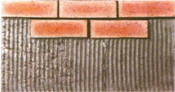 Press the brick veneer firmly and evenly onto the wall surface so that the mortar behind the veneer squeezes out around its sides
